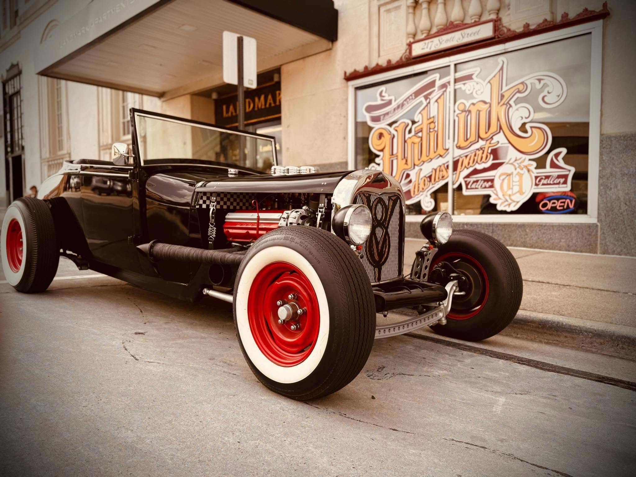 A classic V8 hot rod parked outside the Until Ink Do Us Part Tattoo Gallery storefront on 217 Scott Street in Wausau, Wisconsin